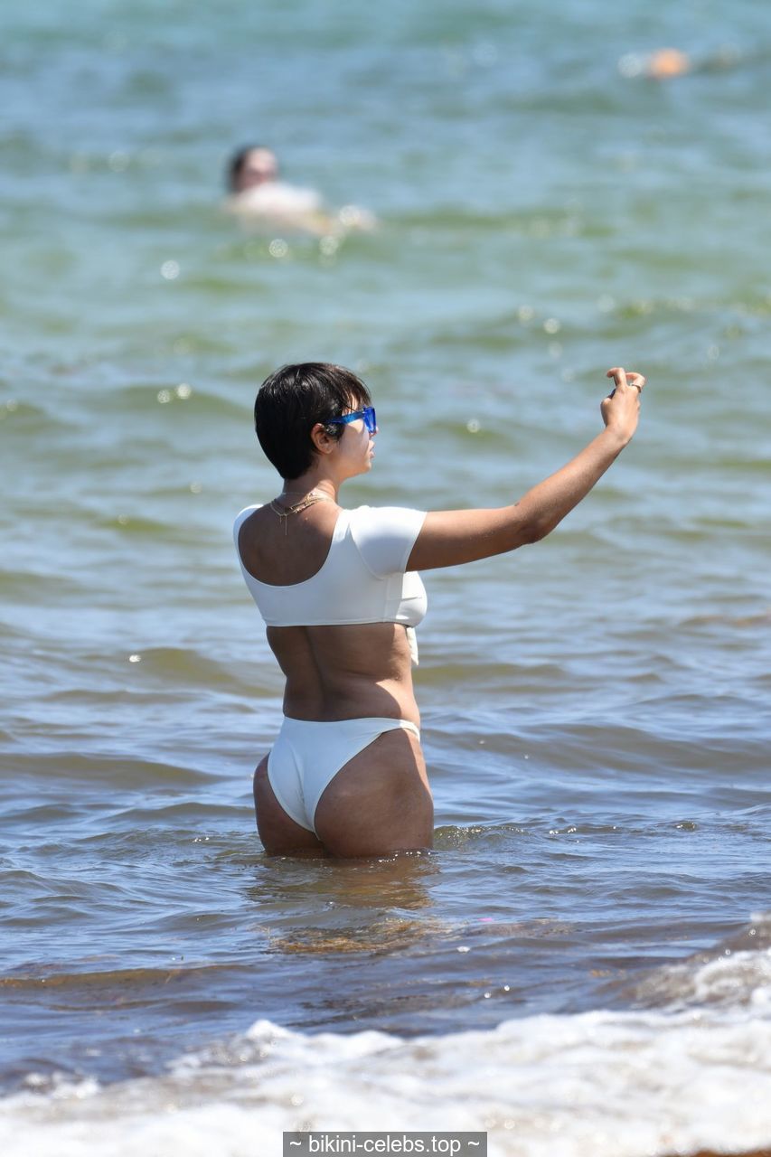 Jackie Cruz cleavage in white bikini on the beach in Miami.